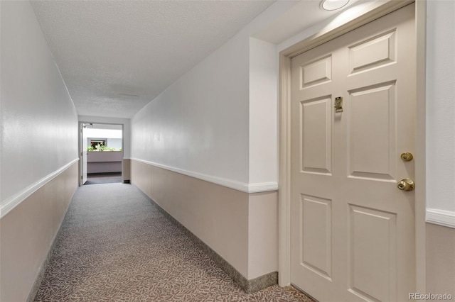 hallway with a textured ceiling