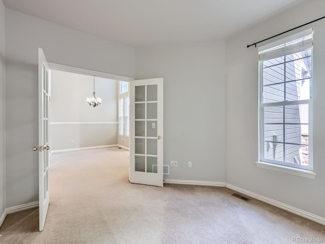 5155 W Quincy Ave Unit J103, Denver, CO 80236 - carpeted spare room featuring a chandelier and french doors