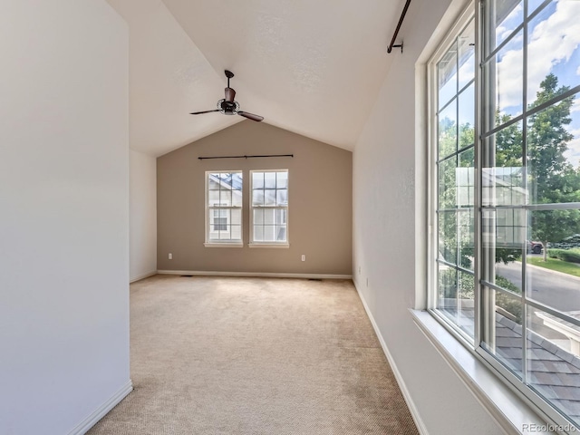 5155 W Quincy Ave Unit J103, Denver, CO 80236 - spare room with plenty of natural light, a ceiling fan, light colored carpet, and vaulted ceiling