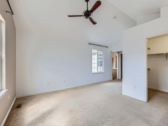 5155 W Quincy Ave Unit J103, Denver, CO 80236 - unfurnished bedroom with light carpet, a spacious closet, a closet, and high vaulted ceiling