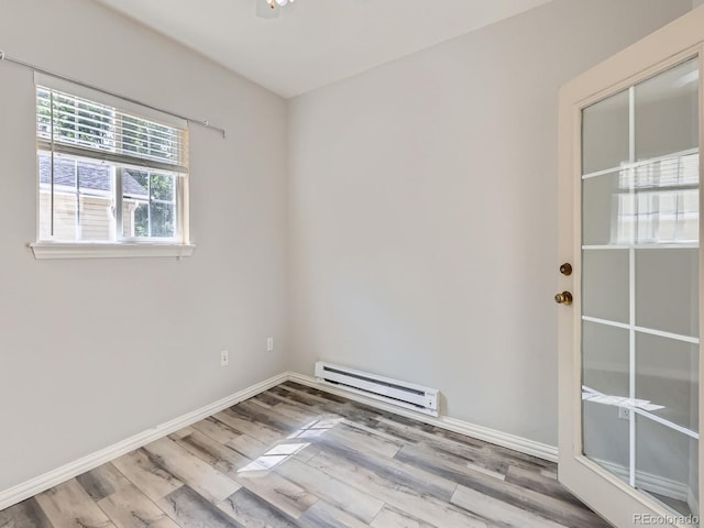 5155 W Quincy Ave Unit J103, Denver, CO 80236 - unfurnished room with baseboard heating and wood finished floors