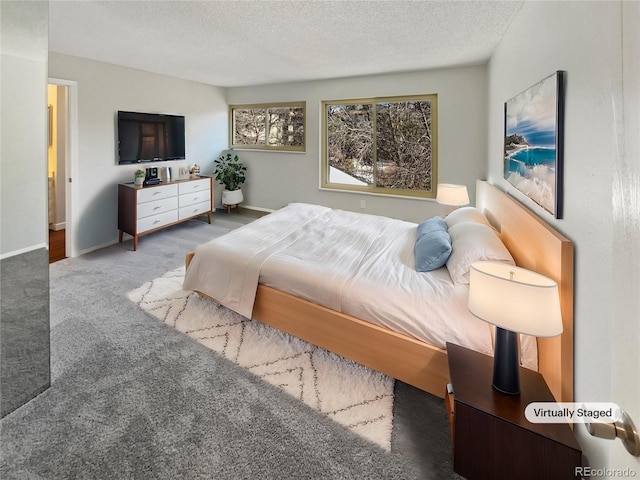 bedroom featuring carpet and a textured ceiling