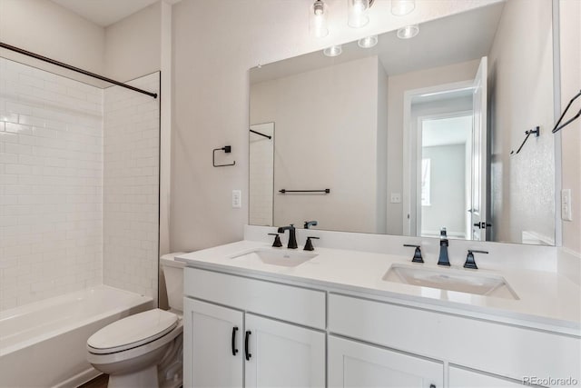 full bathroom with toilet, vanity, and washtub / shower combination