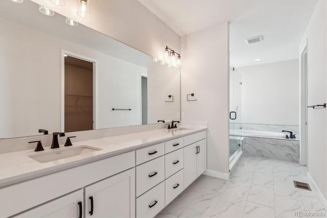 bathroom with vanity and separate shower and tub