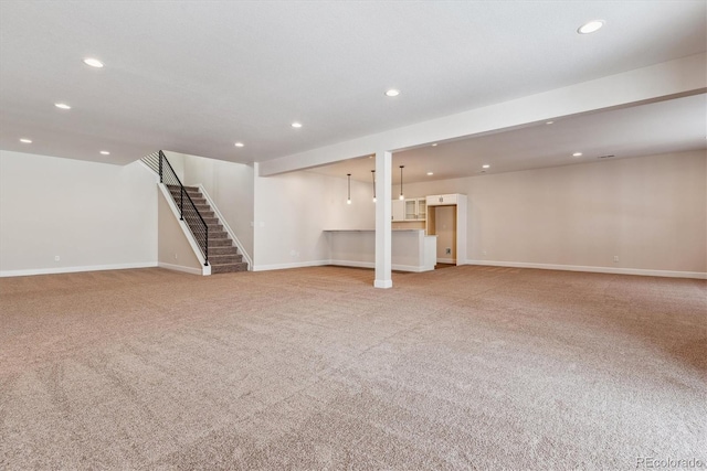 basement featuring light colored carpet