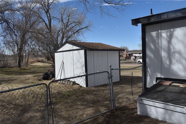 view of shed featuring a gate and fence