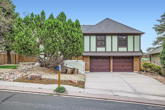 6545 Grey Eagle Ln, Colorado Springs, CO 80919 - english style home with roof with shingles, fence, an attached garage, brick siding, and concrete driveway