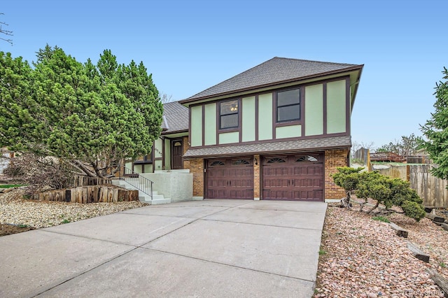 6545 Grey Eagle Ln, Colorado Springs, CO 80919 - view of front of home featuring driveway, a garage, brick siding, fence, and a shingled roof