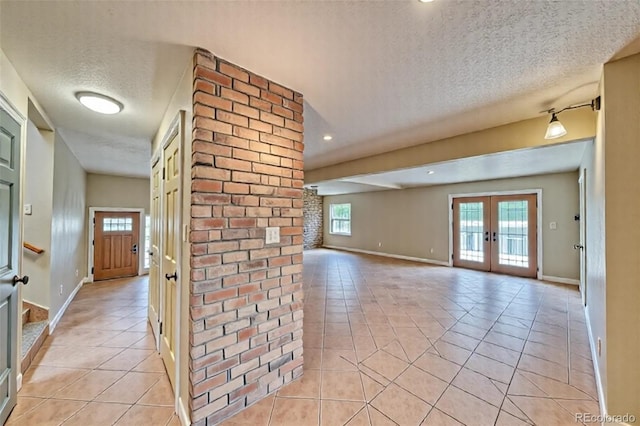 6375 Terrace Ln, Salida, CO 81201 - hall featuring french doors, a textured ceiling, and light tile patterned floors