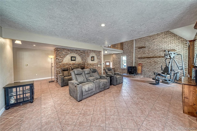 6375 Terrace Ln, Salida, CO 81201 - tiled living room featuring a wood stove, a textured ceiling, and brick wall