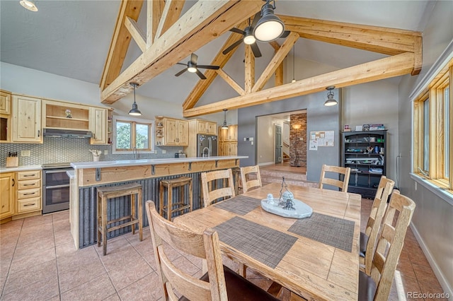 6375 Terrace Ln, Salida, CO 81201 - dining area with beamed ceiling, a ceiling fan, high vaulted ceiling, and light tile patterned flooring