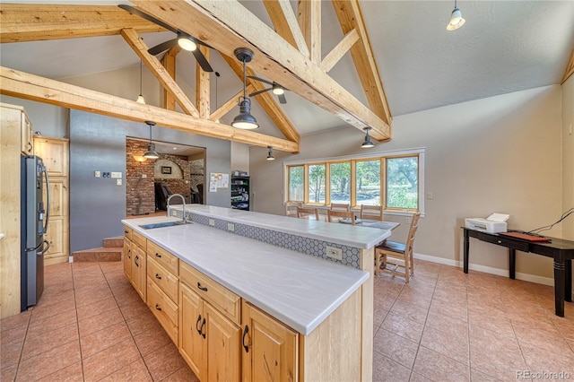 6375 Terrace Ln, Salida, CO 81201 - kitchen with freestanding refrigerator, ceiling fan, light brown cabinets, beamed ceiling, and light countertops