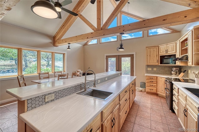 6375 Terrace Ln, Salida, CO 81201 - kitchen with range with two ovens, plenty of natural light, light brown cabinets, backsplash, and beamed ceiling