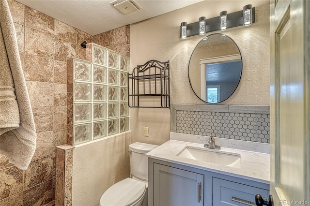 6375 Terrace Ln, Salida, CO 81201 - bathroom featuring a textured wall, a walk in shower, and vanity