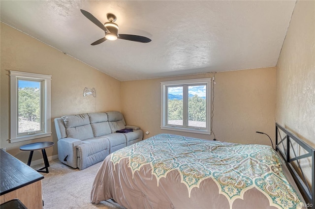 6375 Terrace Ln, Salida, CO 81201 - carpeted bedroom featuring vaulted ceiling, multiple windows, a textured wall, a textured ceiling, and a ceiling fan