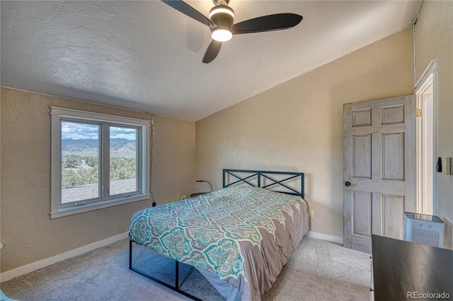 6375 Terrace Ln, Salida, CO 81201 - bedroom featuring a textured wall, carpet floors, lofted ceiling, a ceiling fan, and a textured ceiling