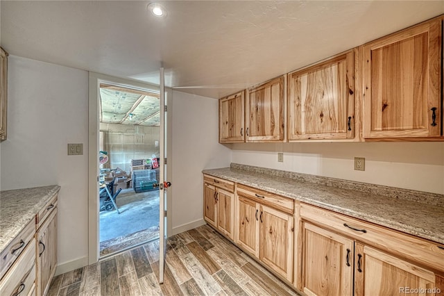 6375 Terrace Ln, Salida, CO 81201 - kitchen with light wood-style floors, light stone countertops, and light brown cabinets