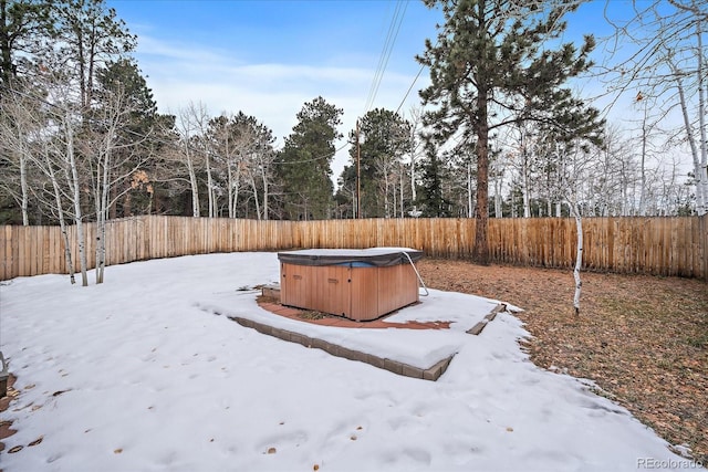 snowy yard with a hot tub