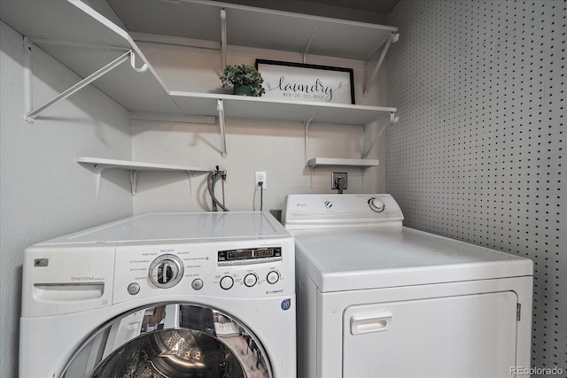 laundry area featuring washing machine and clothes dryer