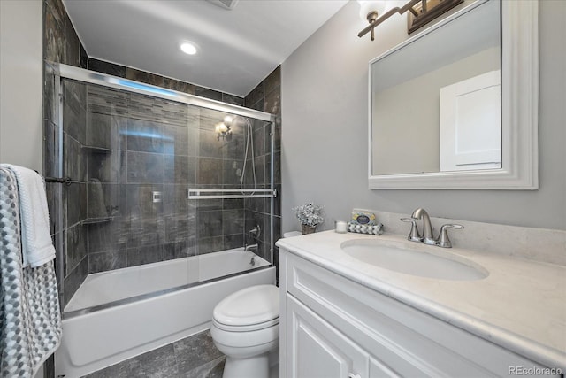 full bathroom featuring shower / bath combination with glass door, vanity, and toilet