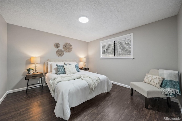 bedroom with dark hardwood / wood-style flooring and a textured ceiling