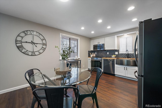 dining room with dark wood-type flooring and sink