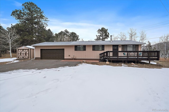 single story home featuring a shed and a deck