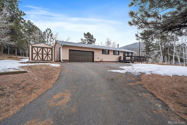 view of front of house with a shed and a wooden deck