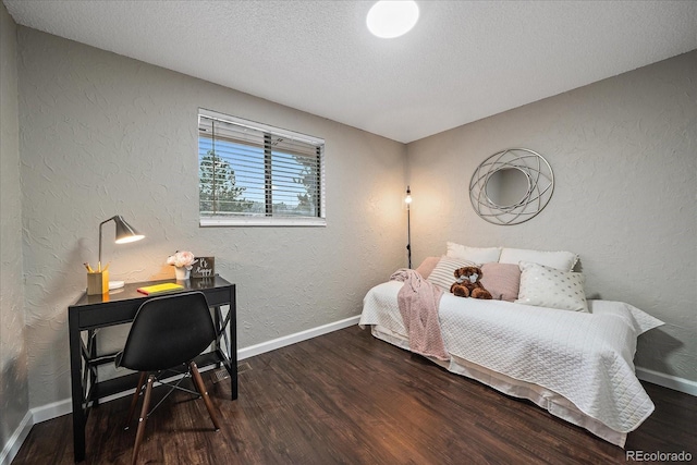 bedroom with wood-type flooring and a textured ceiling