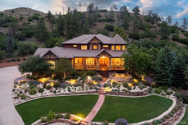 view of front of house with a mountain view and a yard