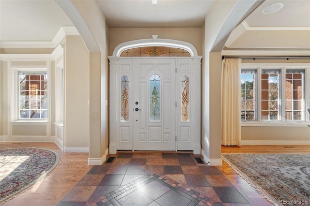 foyer entrance featuring crown molding