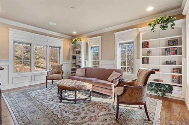 living room with hardwood / wood-style floors and ornamental molding