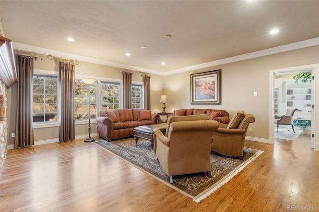 living room with light hardwood / wood-style flooring and ornamental molding