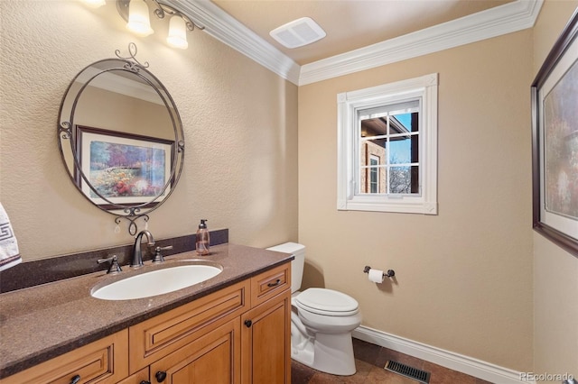 bathroom featuring tile patterned floors, crown molding, vanity, and toilet