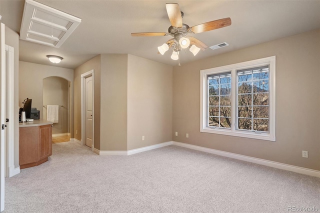 unfurnished room with light colored carpet and ceiling fan