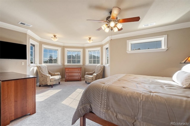 carpeted bedroom with ceiling fan and crown molding