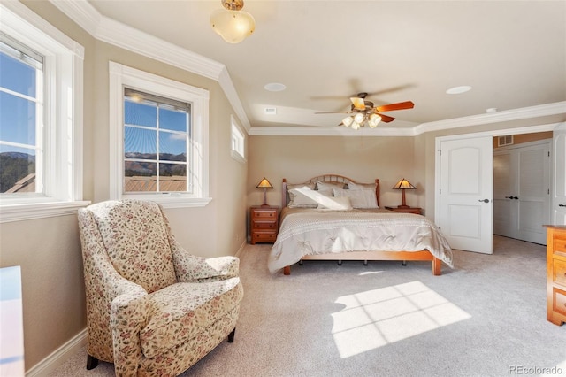 carpeted bedroom featuring ceiling fan and ornamental molding