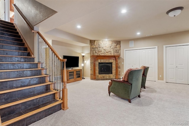 living room featuring a fireplace and carpet flooring