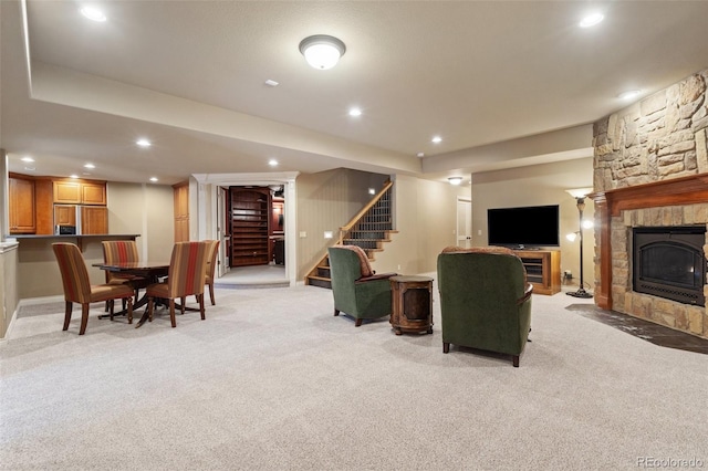 carpeted living room featuring a fireplace