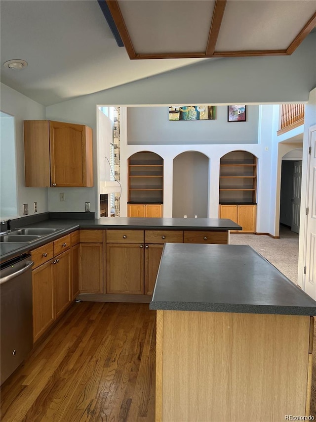 kitchen with dishwasher, a center island, wood-type flooring, and sink