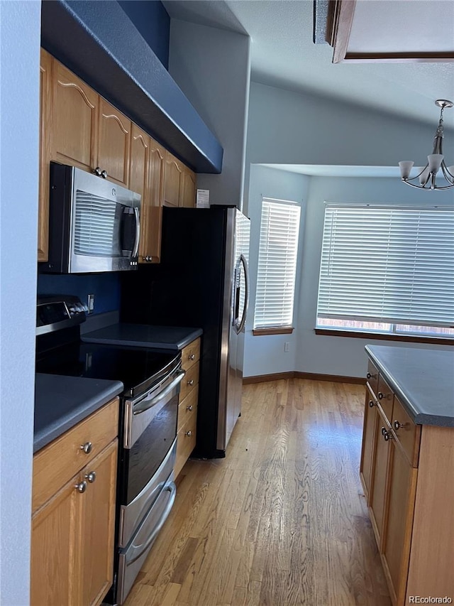 kitchen featuring a chandelier, appliances with stainless steel finishes, light hardwood / wood-style floors, and decorative light fixtures