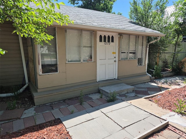 1272 N Ulster St, Denver, CO 80220 - view of exterior entry with a shingled roof