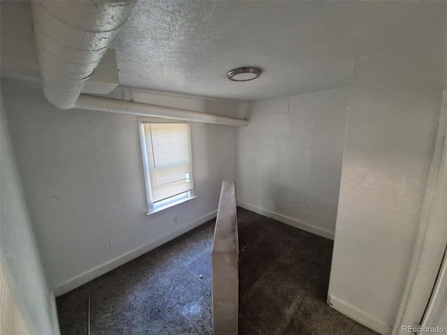 1272 N Ulster St, Denver, CO 80220 - unfurnished room featuring baseboards and a textured ceiling