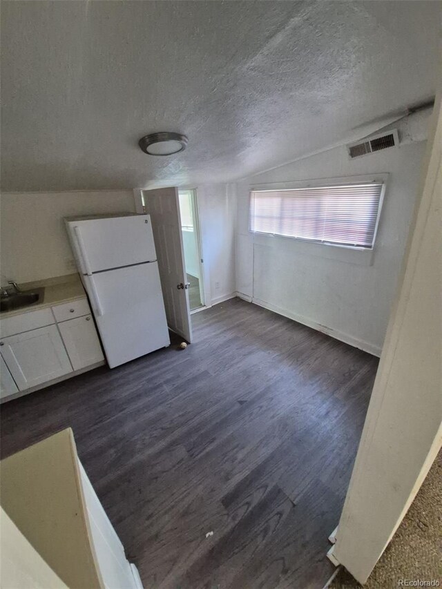 1272 N Ulster St, Denver, CO 80220 - unfurnished dining area with dark wood-style floors, a textured ceiling, baseboards, and a sink