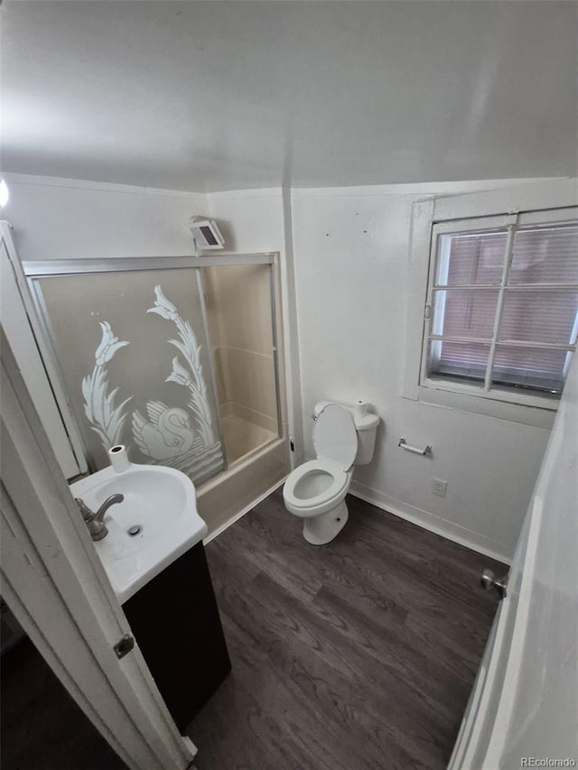 1272 N Ulster St, Denver, CO 80220 - full bathroom featuring vanity, toilet, wood finished floors, tub / shower combination, and baseboards