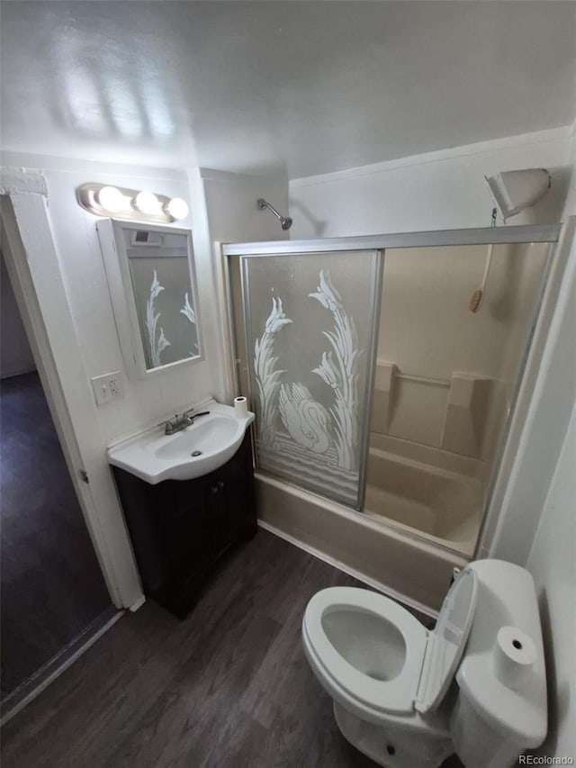 1272 N Ulster St, Denver, CO 80220 - bathroom featuring toilet, vanity, wood finished floors, and shower / bath combination with glass door
