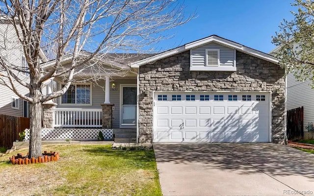 view of front facade with covered porch, a garage, and a front lawn