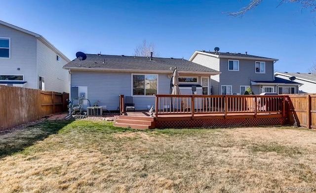 back of property featuring central AC unit, a yard, and a wooden deck