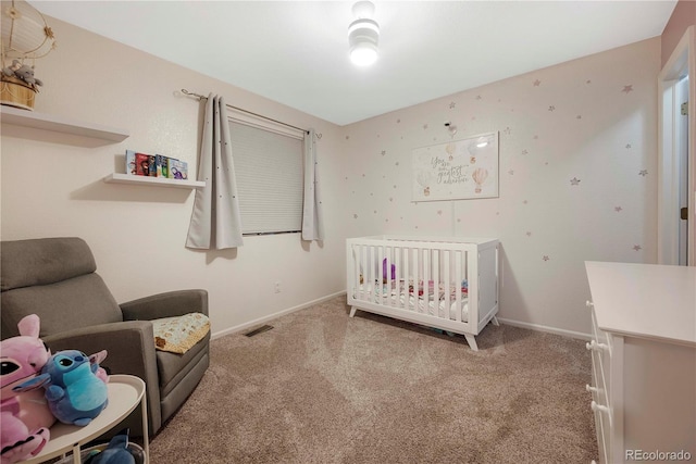 carpeted bedroom with a crib