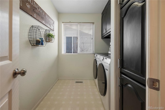 laundry area with cabinets and washing machine and clothes dryer